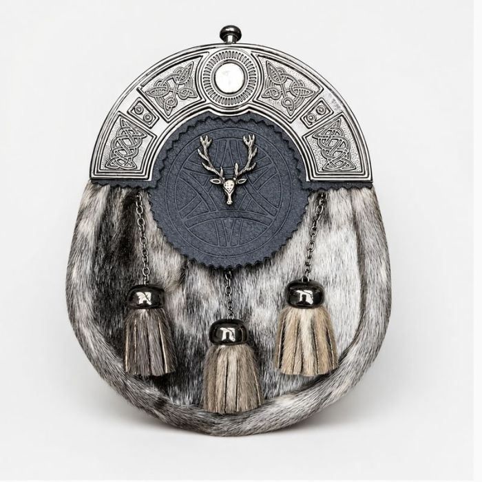 Traditional seal skin Scottish sporran with silver Celtic cantle, black leather flap, stag emblem, and three tassels.