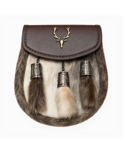 Traditional seal skin Scottish sporran with silver Celtic cantle, black leather flap, stag emblem, and three tassels.