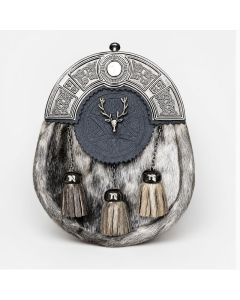 Traditional seal skin Scottish sporran with silver Celtic cantle, black leather flap, stag emblem, and three tassels.